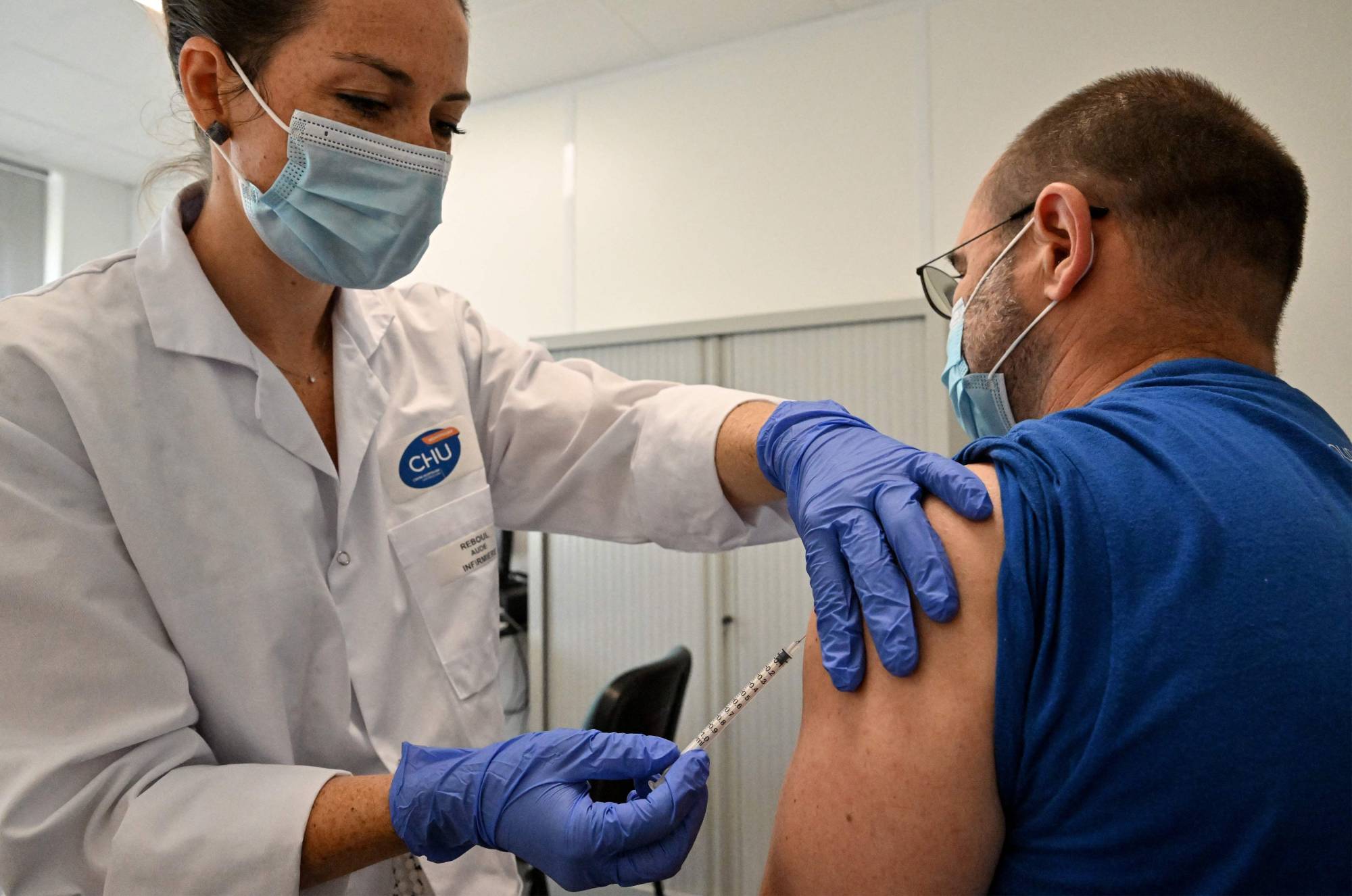 A nurse vaccinates a patient against monkeypox in Montpellier, southern France, on Aug. 23. | AFP-Jiji