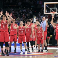 Akatsuki Japan players wave to the crowd after their win over Kazakhstan in Okinawa on Tuesday. | KYODO