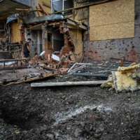A man walks through the rubble of a damaged building after shelling in Kharkiv on Tuesday. | AFP-JIJI