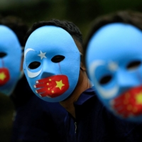 Activists take part in a protest against China\'s treatment toward the ethnic Uyghur people and call for a boycott of the 2022 Winter Olympics in Beijing, at a park in Jakarta, on Jan. 4. | REUTERS