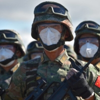 Chinese service members take part in a ceremony opening Vostok 2022 military exercises at a firing ground in the far eastern Primorsky region, Russia, on Wednesday. | RUSSIAN DEFENSE MINISTRY / VIA REUTERS