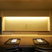 The dining room at Kamakura Kitajima is spare and uncluttered in traditional Japanese style with eight seats at the polished timber counter overlooking chef Yasunori Kitajima’s workspace. | KOUTAROU WASHIZAKI
