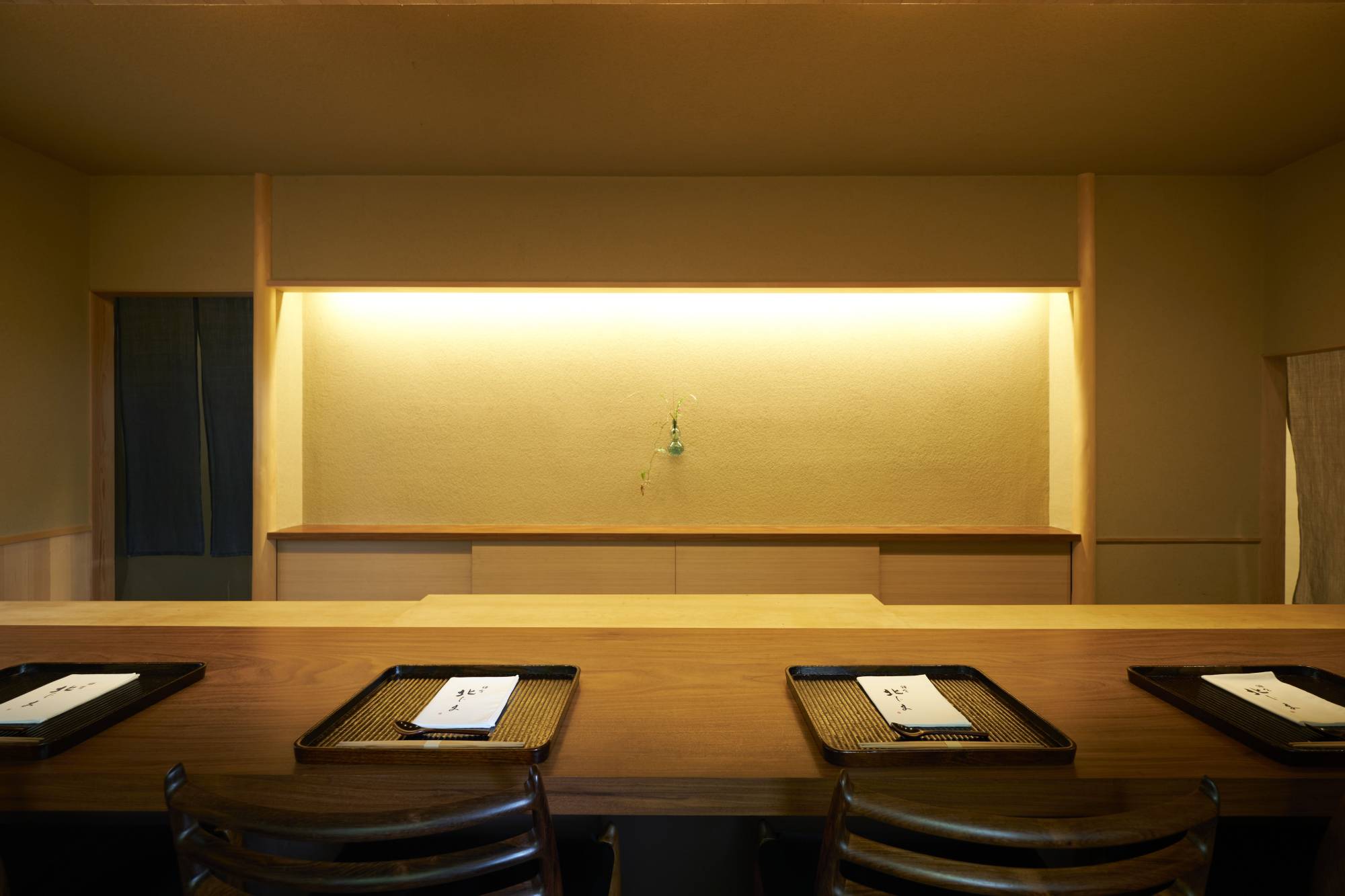 The dining room at Kamakura Kitajima is spare and uncluttered in traditional Japanese style with eight seats at the polished timber counter overlooking chef Yasunori Kitajima’s workspace. | KOUTAROU WASHIZAKI