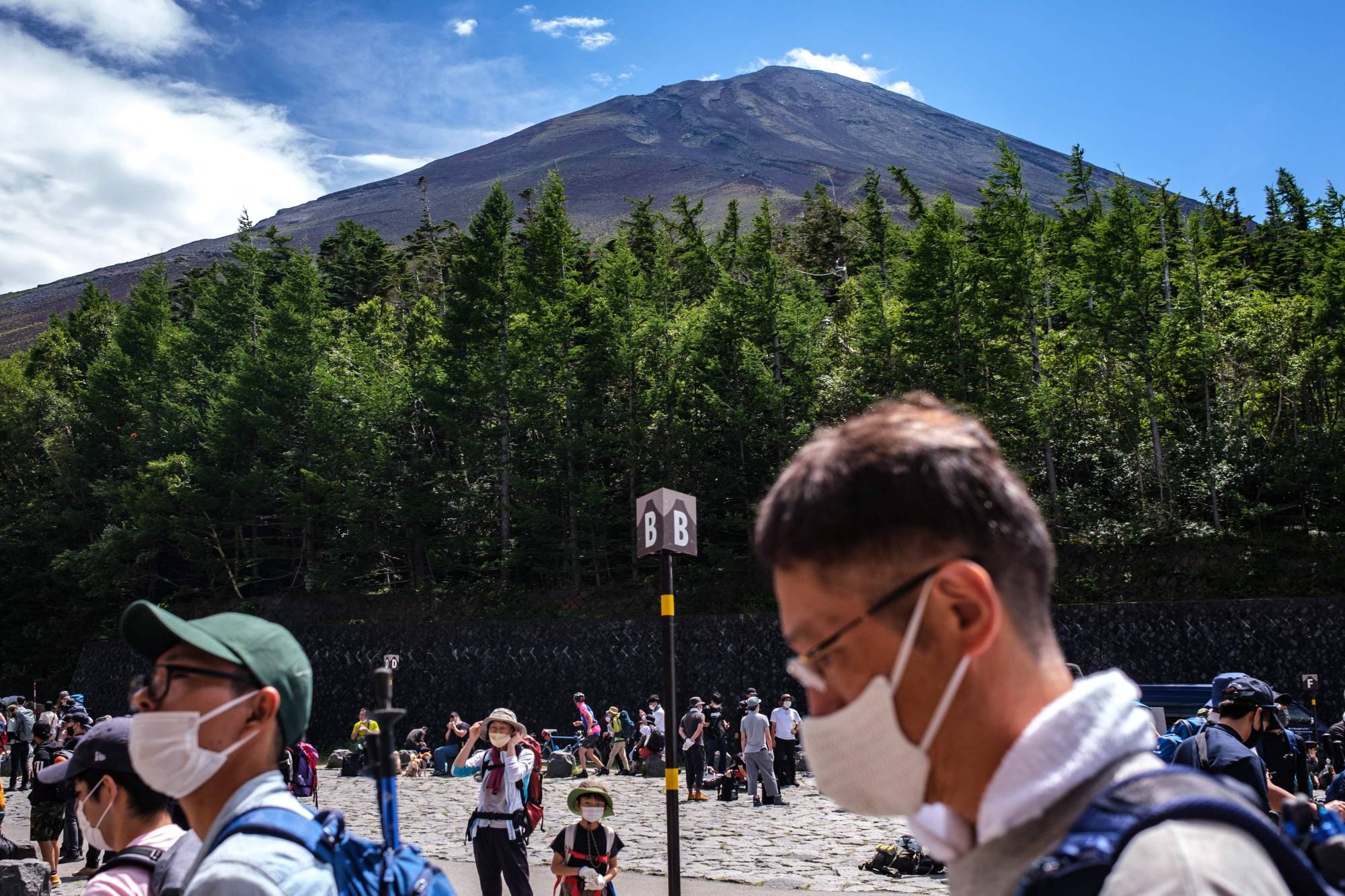 Tourists gather at bus terminals near Mount Fuji on Aug. 14. | AFP-JIJI