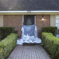 Sandbags and plastic tarps protect a home from flooding in Jackson, Mississippi, on Wednesday. | EDMUND FOUNTAIN / THE NEW YORK TIMES