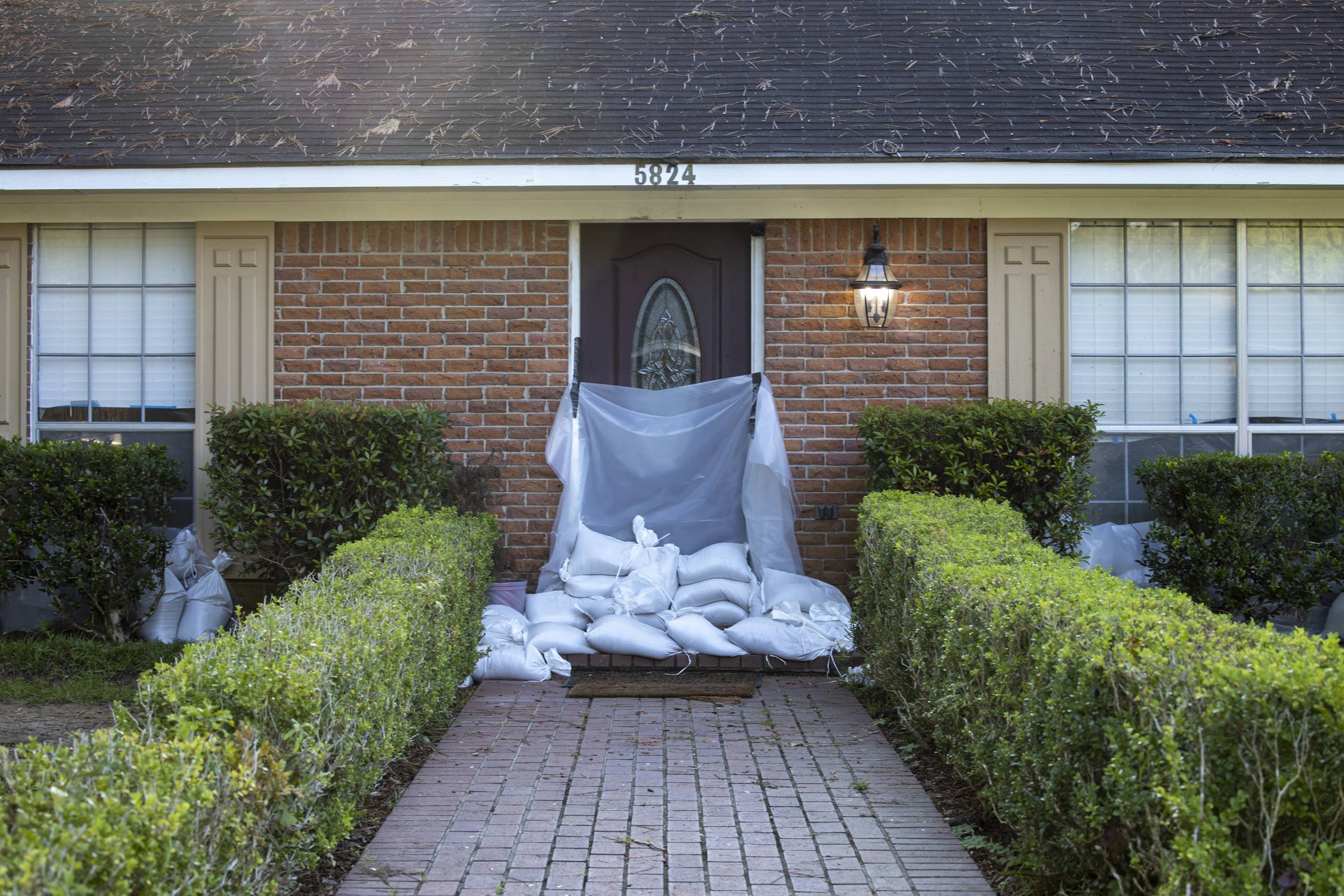 Sandbags and plastic tarps protect a home from flooding in Jackson, Mississippi, on Wednesday. | Edmund Fountain / The New York Times