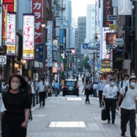 People walk through the Shimbashi district in Tokyo on Monday. | AFP-JIJI