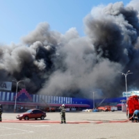 Smoke rises above a burning shopping mall in Donetsk, Ukraine, on Aug. 24. The war in Ukraine has seen numerous examples of civilian technologies employed on the battlefield. | REUTERS