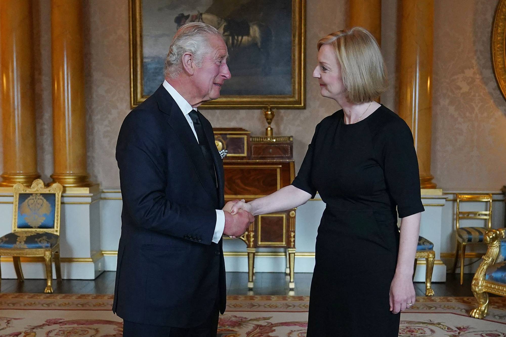 Britain's King Charles III greets Prime Minister Liz Truss during their first meeting at Buckingham Palace on Friday. | POOL / via AFP-JIJI