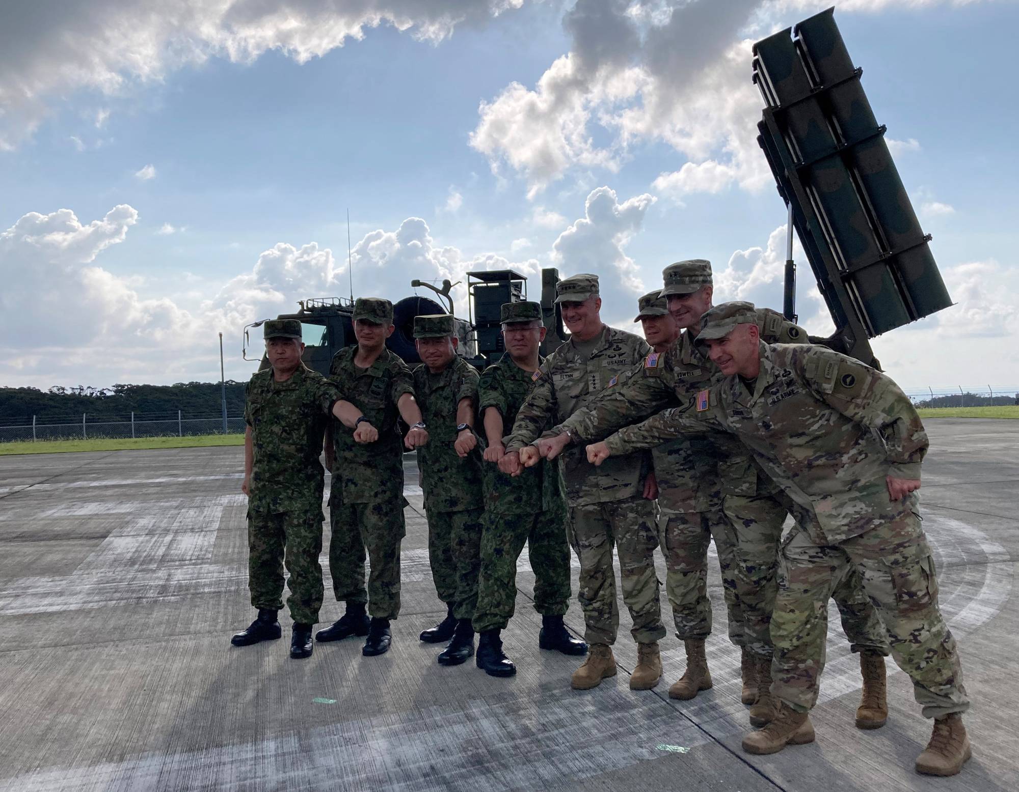 U.S. Army Pacific chief Gen. Charles Flynn (fourth from right) poses with Gen. Yoshida Yoshihide (fourth from left), Ground Self-Defense Force chief of staff, and other officers at a Ground Self-Defense Force base on Amami Oshima island, Kagoshima Prefecture, on Thursday. | REUTERS