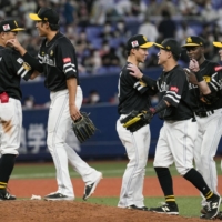SoftBank players celebrate their win over the Buffaloes in Osaka on Sunday. | KYODO