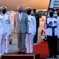 Then-Prince Charles, now the king, bids farewell as he prepares to leave Barbados after taking part in events to mark the transition of the island country to a newly created republic in November. | REUTERS