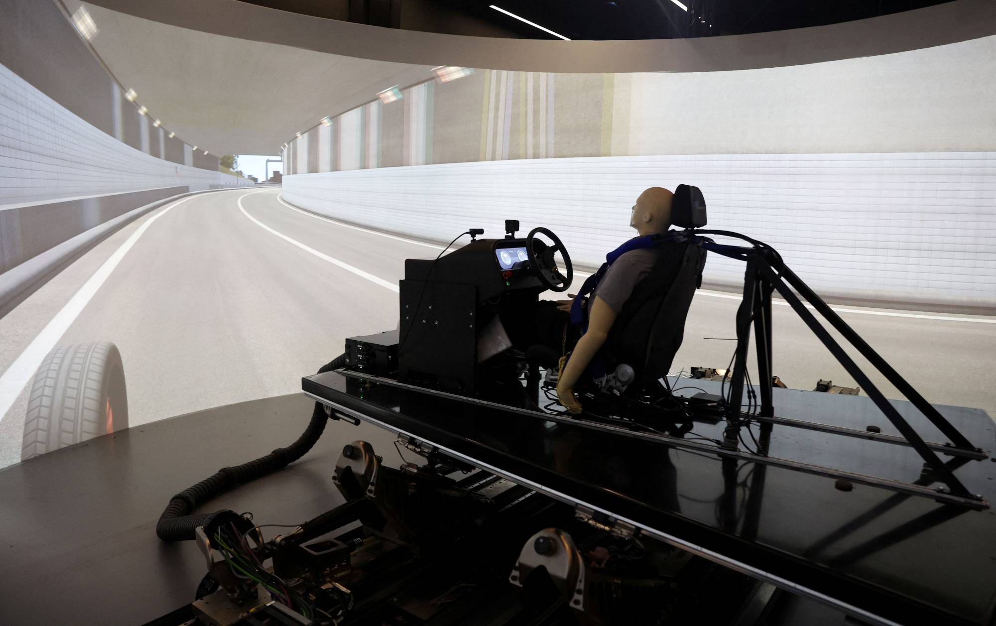 AB Dynamics staff run a demonstration of the advanced Vehicle Driving Simulator (aVDS) in Bradford on Avon, England, on June 20. | Reuters 
