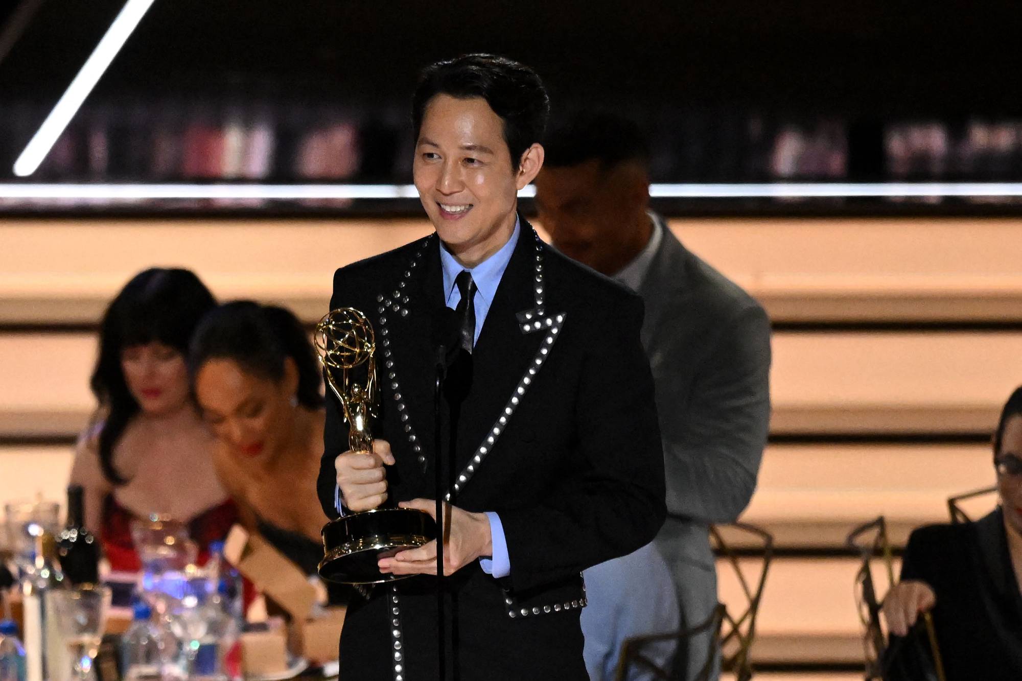 South Korean actor Lee Jung-jae accepts the award for outstanding lead actor in a drama series for 'Squid Game' during the 74th Emmy Awards on Monday night. | AFP-JIJI