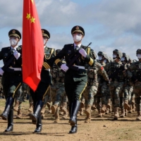 Chinese service members take part in a ceremony for the opening of the Vostok 2022 military exercises at a firing ground in Russia\'s far eastern Primorsky region on Aug. 31.  | RUSSIAN DEFENSE MINISTRY / VIA REUTERS