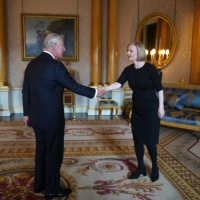 King Charles III greets Britain\'s new prime minister, Liz Truss, during their first meeting at Buckingham Palace in London on Friday. | POOL / AFP-JIJ