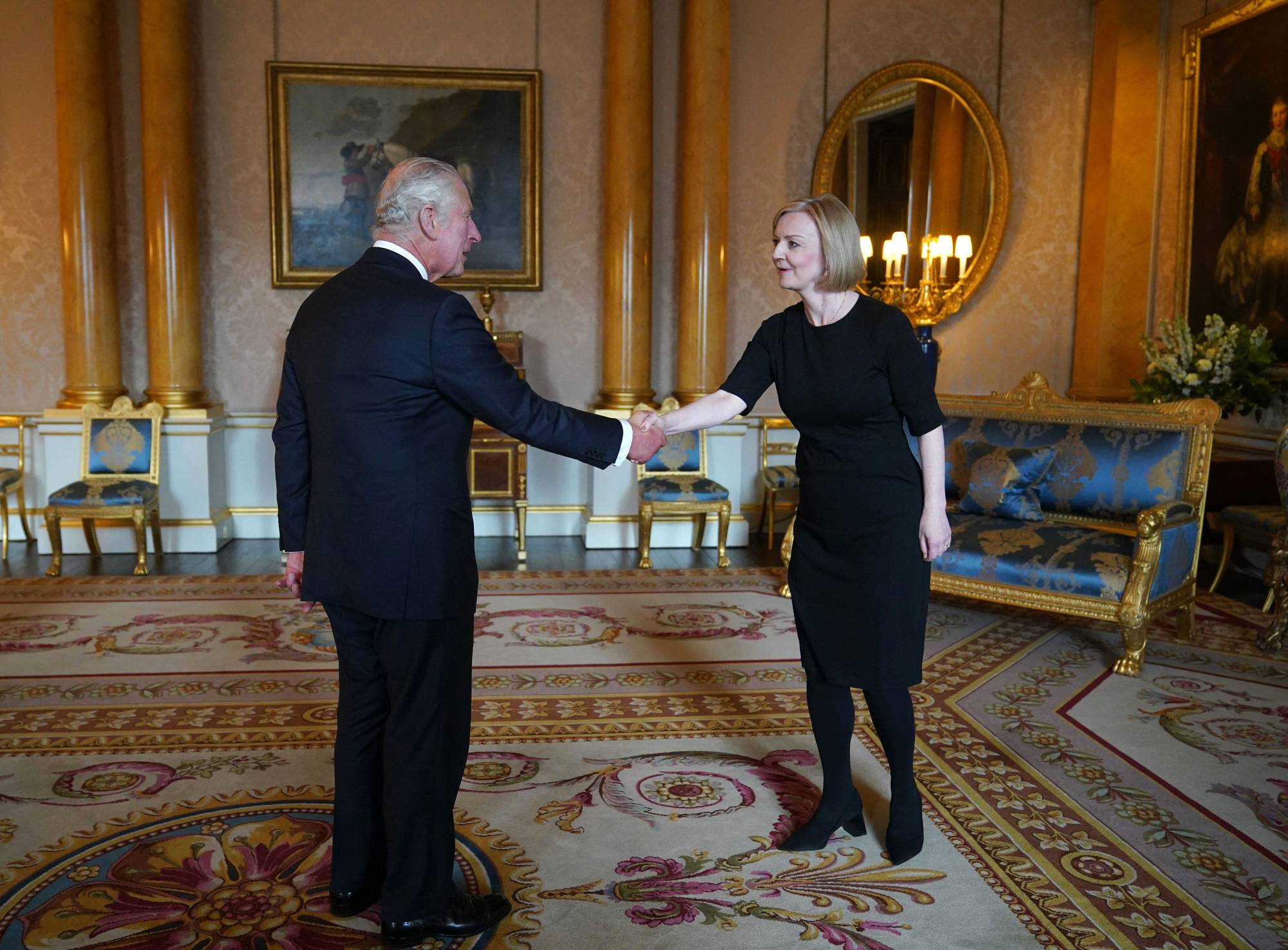 King Charles III greets Britain's new prime minister, Liz Truss, during their first meeting at Buckingham Palace in London on Friday. | POOL / AFP-JIJ