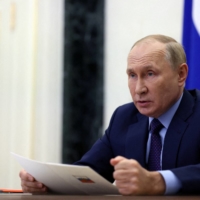 Russian President Vladimir Putin chairs a meeting with members of the Security Council via a video conference call in Moscow on Friday. | POOL / SPUTNIK / VIA REUTERS 