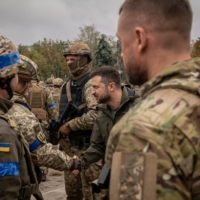 President Volodymyr Zelenskyy of Ukraine makes an unannounced visit to a flag-raising ceremony in the main square of the recaptured city of Izium on Wednesday. | NICOLE TUNG / THE NEW YORK TIMES