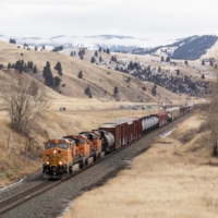 A freight train travels through Montana in January 2021. U.S. rail workers have gone three years without a raise amid a contract dispute, while rail companies have recorded robust profits. | TAILYR IRVINE / THE NEW YORK TIMES