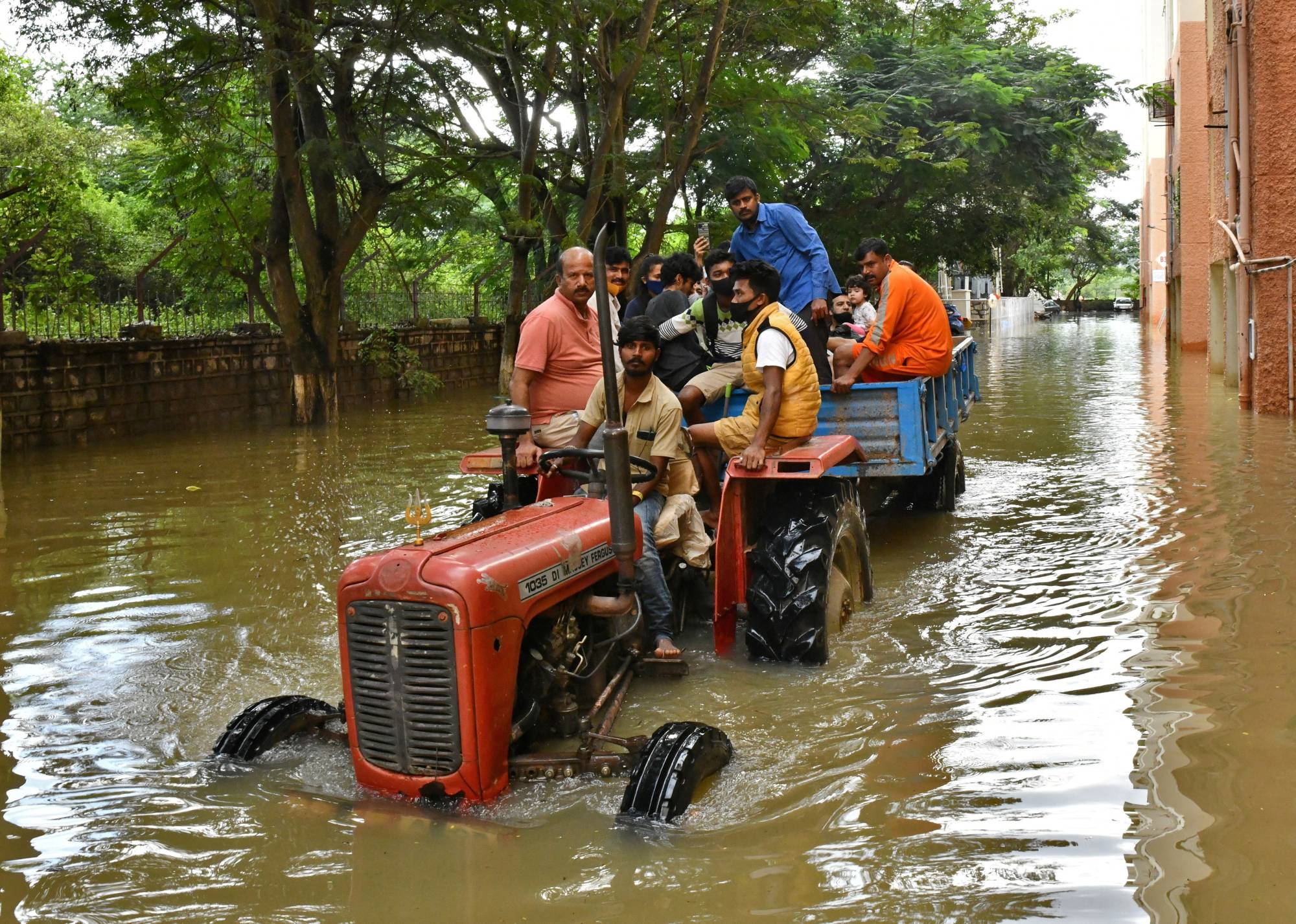 Residents are evacuated to safer places in a tractor after heavy rains caused flooding in a residential area of Bengaluru in November 2021.  | REUTERS 