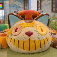 The Cat Bus character from \"My Neighbor Totoro\" inside a playroom in Ghibli\'s Grand Warehouse at Ghibli Park | © STUDIO GHIBLI / VIA KYODO