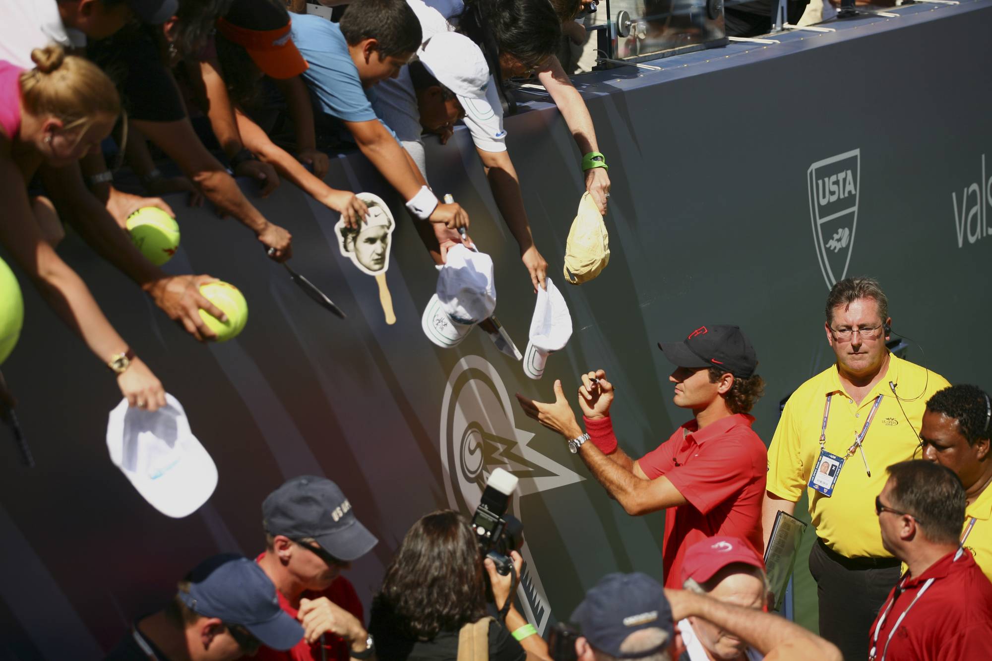 Federer signs autographs during Aurthur Ashe Kids’ Day, before the start of the U.S. Open in New York, on Aug. 23, 2008. Tennis has treated me more generously than I ever would have dreamed and now I must recognize when it is time to end my competitive career, Federer said. | Michael Nagle / The New York Times