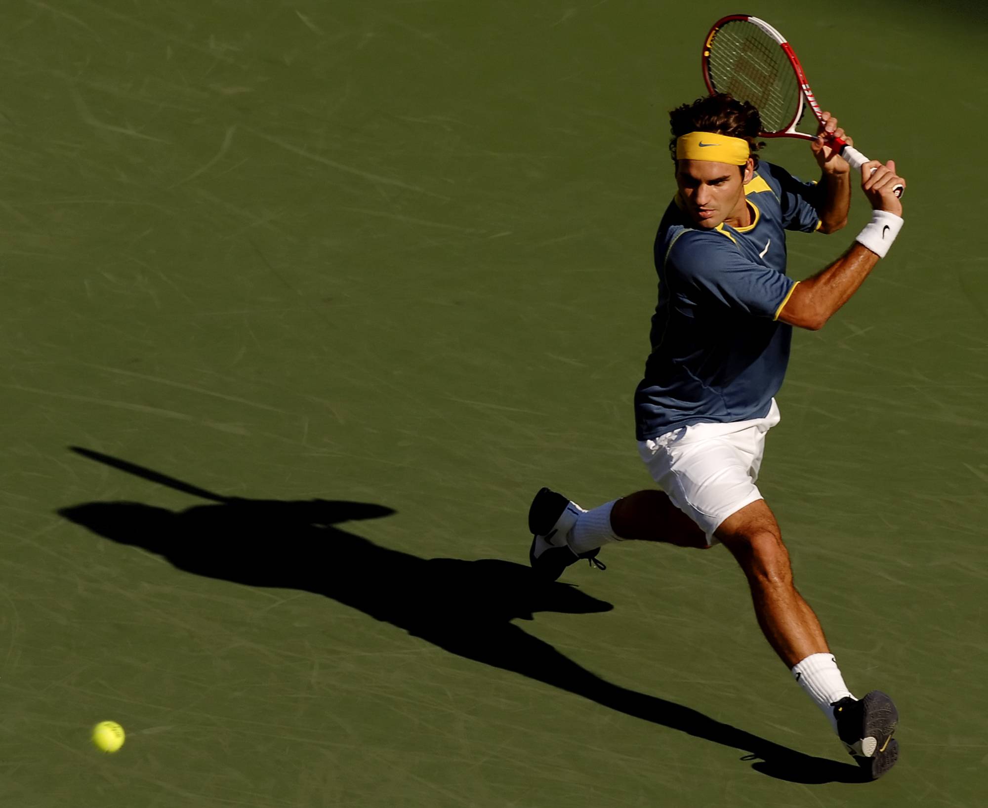 Federer returns a volley from Lleyton Hewitt during a match at the 2005 U.S. Open in New York, on Sept. 10, 2005. Tennis had lost its cachet in the early 2000s before Federer made the classic sport modern and the modern sport classier. | Robert Caplin / The New York Times