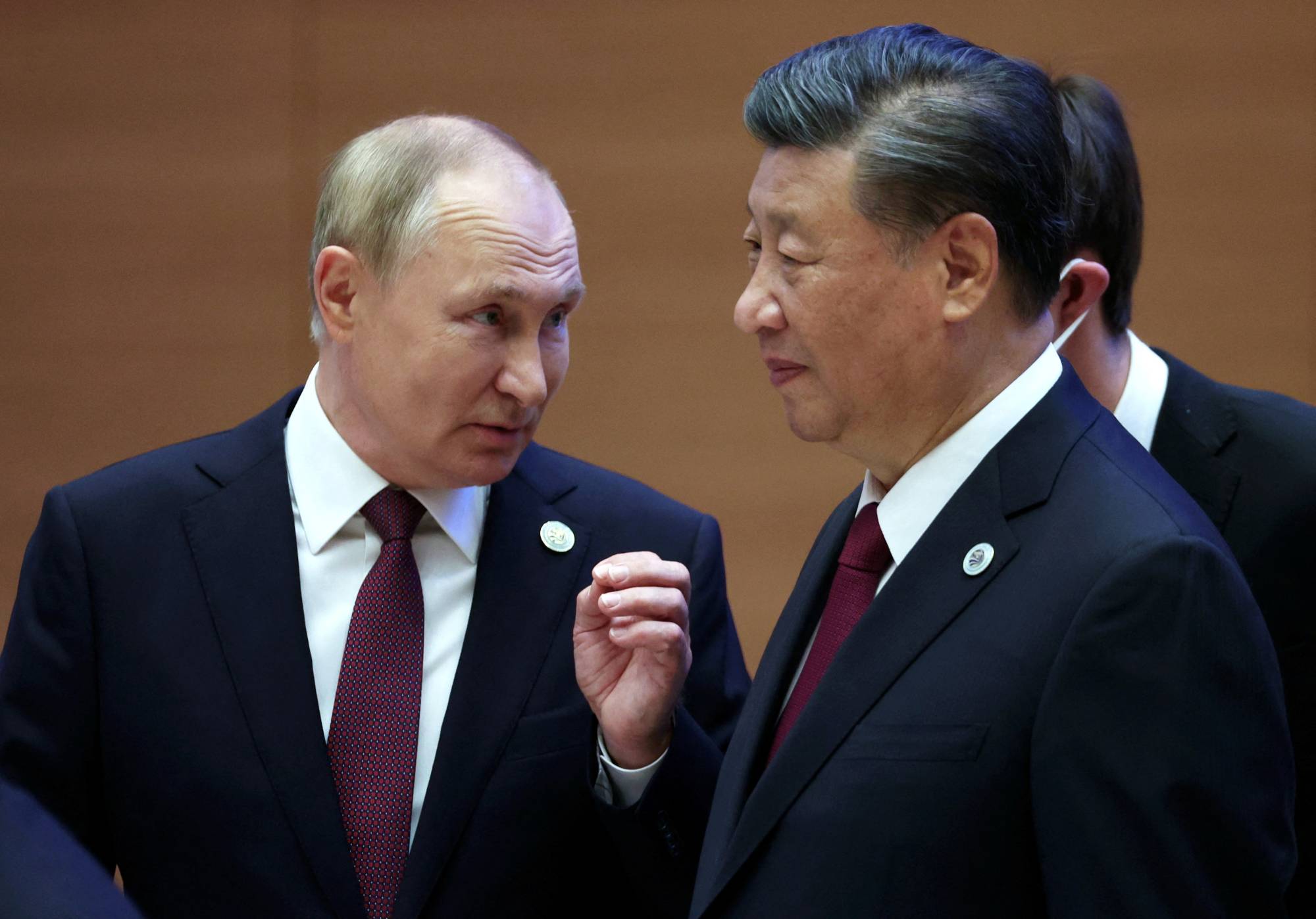 Russian President Vladimir Putin speaks with Chinese President Xi Jinping during a summit in Samarkand, Uzbekistan, on Friday.  | SPUTNIK / VIA REUTERS