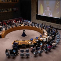 Ukrainian President Volodymyr Zelenskyy appears on a screen as he addresses a U.N. Security Council meeting on the war in Ukraine on Aug. 24 at United Nations headquarters in New York. | AFP-JIJI