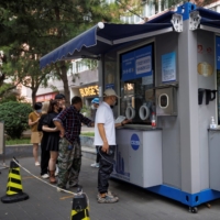 A COVID-19 testing booth in Beijing. Sporadic COVID-19 outbreaks and lockdowns have weakened China’s growth, which ADB said will be slower than the rest of developing Asia. | REUTERS