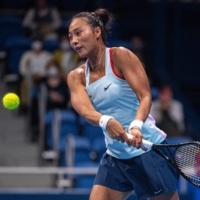 Zheng Qinwen of China hits a return against Misaki Doi of Japan during their women\'s singles match on day one of the Pan Pacific Open tennis tournament in Tokyo on Monday. | AFP-JIJI