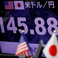 A foreign exchange monitor shows the yen topping the ¥145 line against the dollar in Tokyo on Thursday.
 | REUTERS