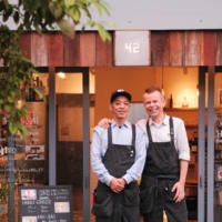 Fumihiro Tanaka and Stephen Milne stand in front of 42, a cafe in Tokyo\'s Higashinagasaki neighborhood that sells Ojizo Coffee.  | STEPHAN JARVIS