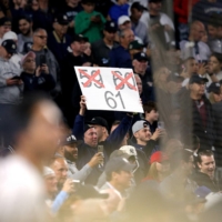 A fan holds a sign counting down the number of home runs New York Yankees right fielder Judge has during a Judge at-bat against the Boston Red Sox during the ninth inning at Yankee Stadium on Thursday. | USA TODAY / VIA REUTERS