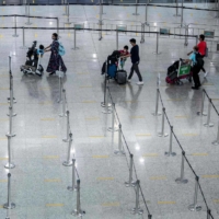 Travelers arrive at Hong Kong International Airport before making their way to hotel quarantine on Friday. | AFP-JIJI