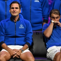 Federer and doubles partner and longtime rival Rafael Nadal show their emotions after Federer\'s final match on Friday in London.  | AFP-JIJI