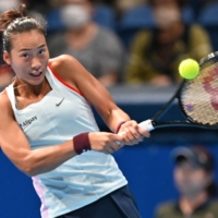 Zheng Qinwen hits a return against Veronika Kudermetova during the Pan Pacific Open semifinals at Ariake Coliseum on Saturday. | AFP-JIJI