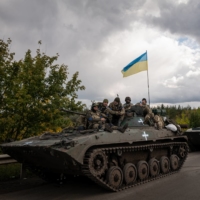 Ukrainian soldiers in armored vehicles in Izium on Saturday. Ukraine’s president has urged citizens to resist the Russians in occupied territories, where voting is under way in what Western officials have called \"sham” referendums on joining Russia. | NICOLE TUNG / THE NEW YORK TIMES