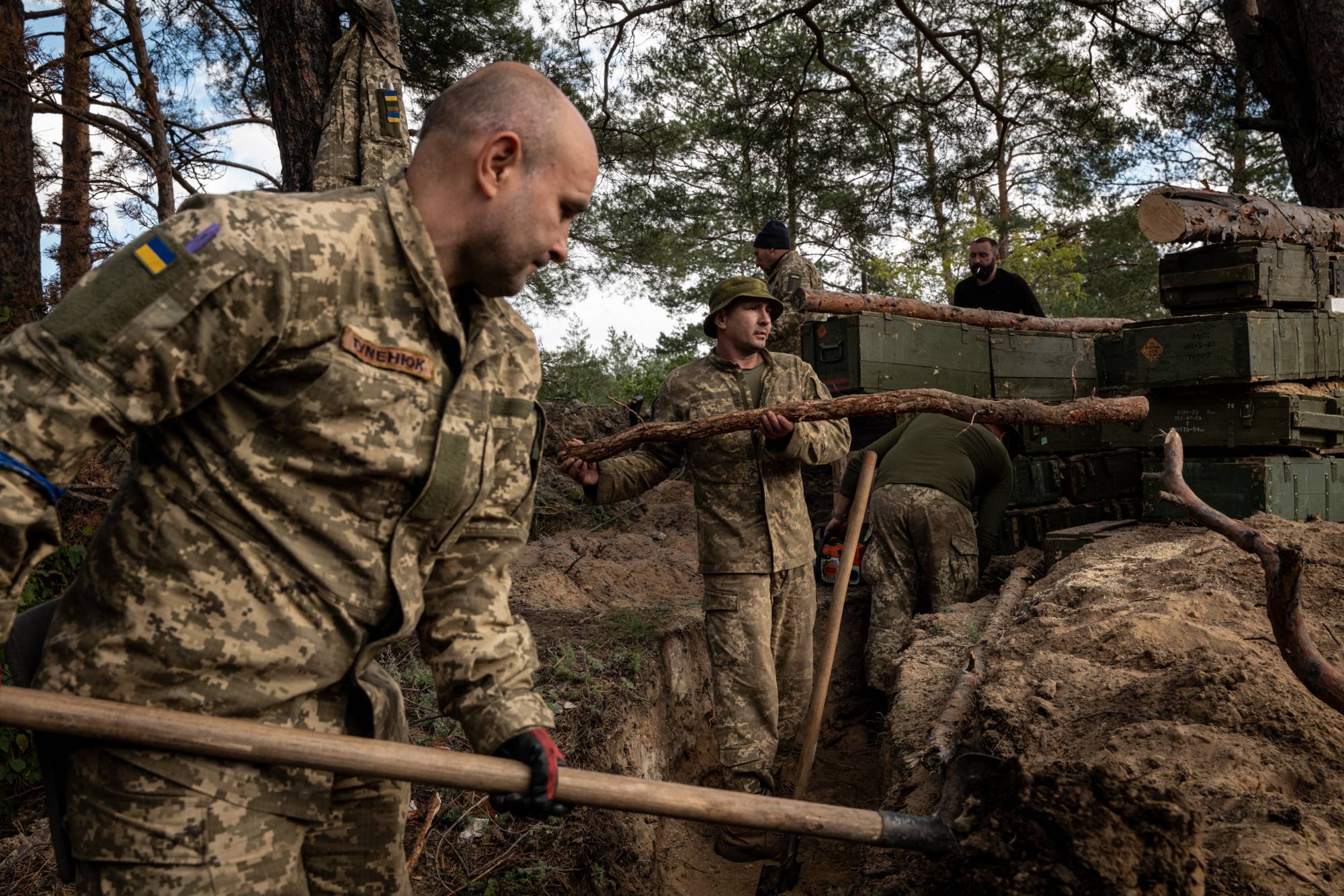 Ukrainian soldiers dig trenches in front-line positions recently recaptured from Russian forces near Oskil, Ukraine, on Saturday. | Nicole Tung / The New York Times
