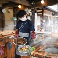 Seafood and vegetables are steamed over a hot spring at a restaurant in the Kannawa Onsen area of Beppu, Oita Prefecture. | BLOOMBERG