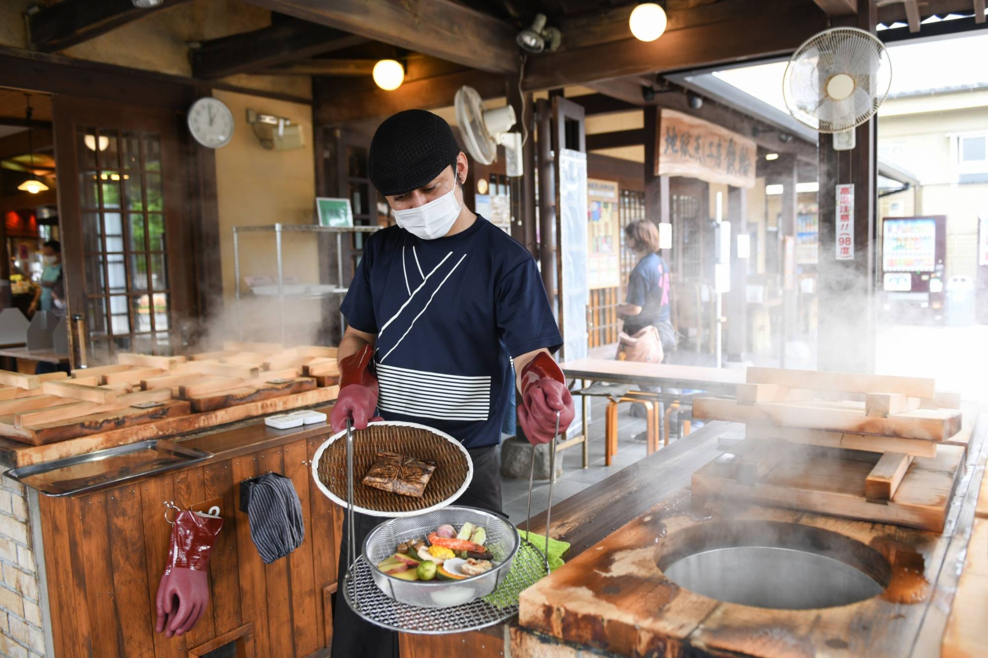 Seafood and vegetables are steamed over a hot spring at a restaurant in the Kannawa Onsen area of Beppu, Oita Prefecture. | BLOOMBERG