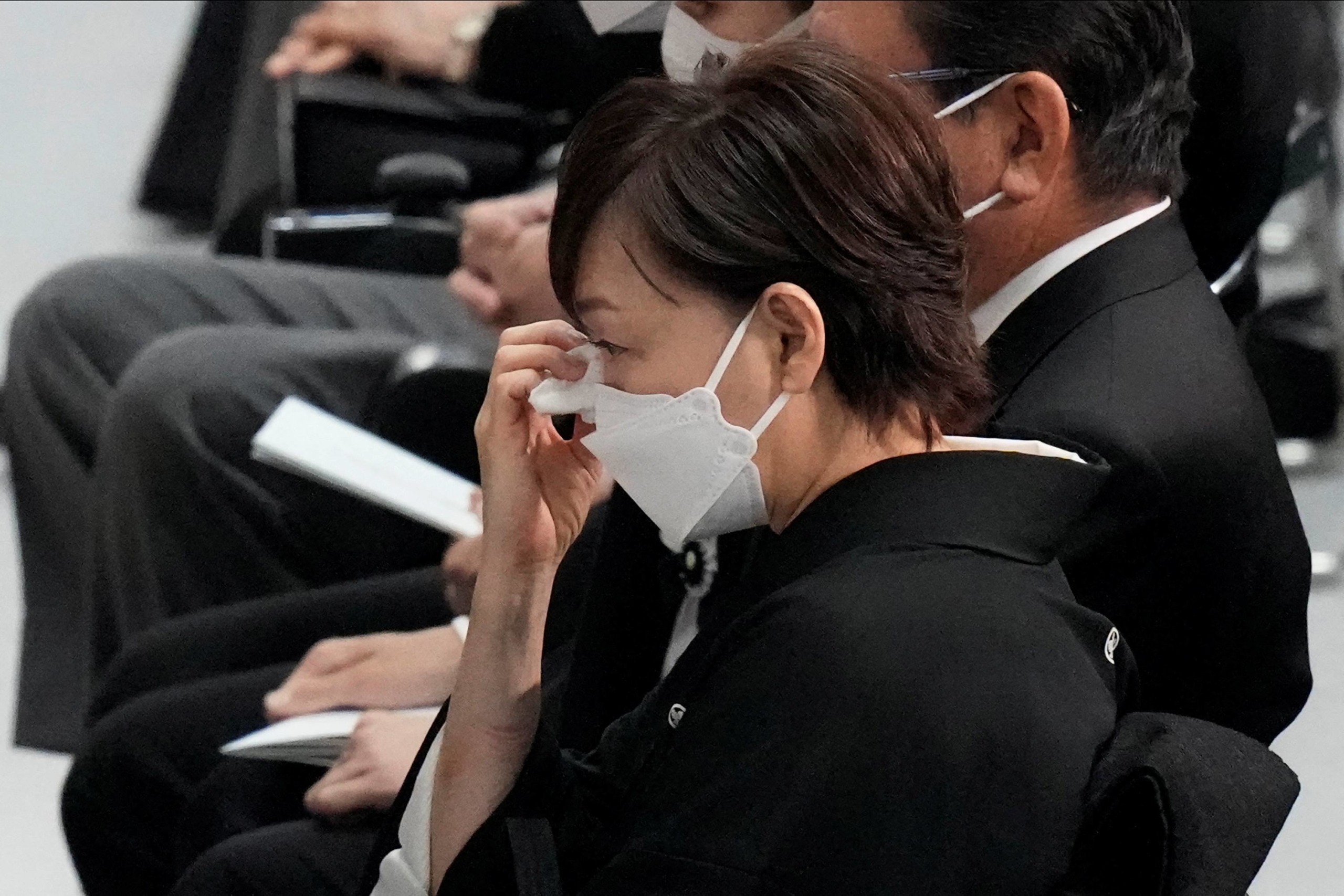 Akie Abe wipes away tears during the state funeral of her husband. | POOL / VIA REUTERS