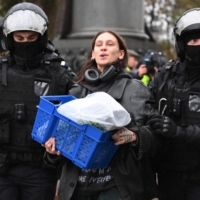 Police officers detain a demonstrator in Moscow on Saturday protesting against the partial mobilization announced by the Russian President Vladimir Putin last week. 

 | AFP-JIJI