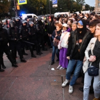 Russian demonstrators opposed to President Vladimir Putin\'s partial mobilization plans face off with police officers in St. Petersburg on Sept. 21. | AFP-JIJI