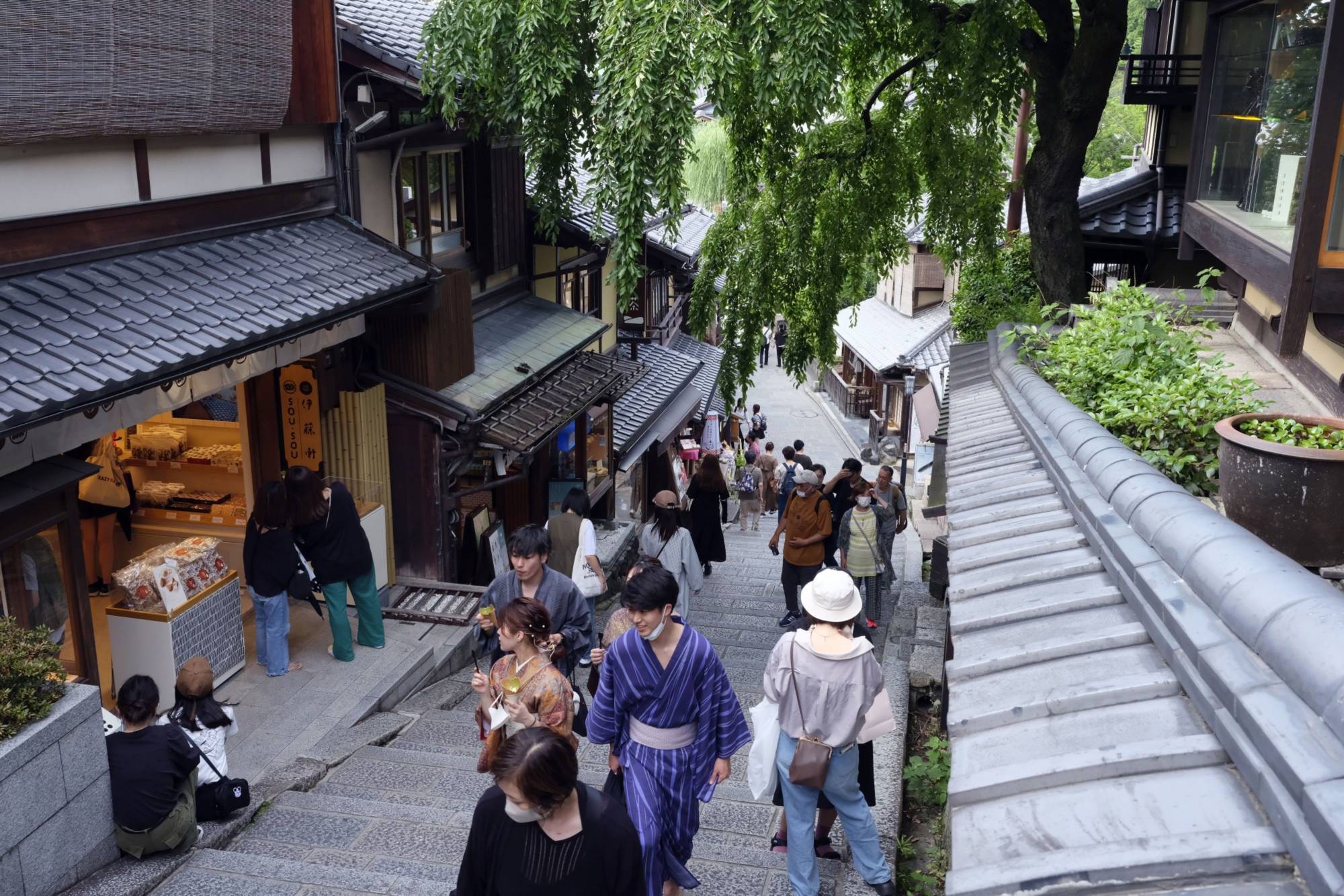 Visitors on the Sannenzaka slope in Kyoto in June. With the yen at quarter-century lows against the dollar, the archipelago is now an affordable and attractive destination for overseas visitors. | BLOOMBERG