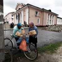 Two women who received humanitarian aid in the recently liberated town of Izium, in Kharkiv region, Ukraine, on Tuesday. | REUTERS