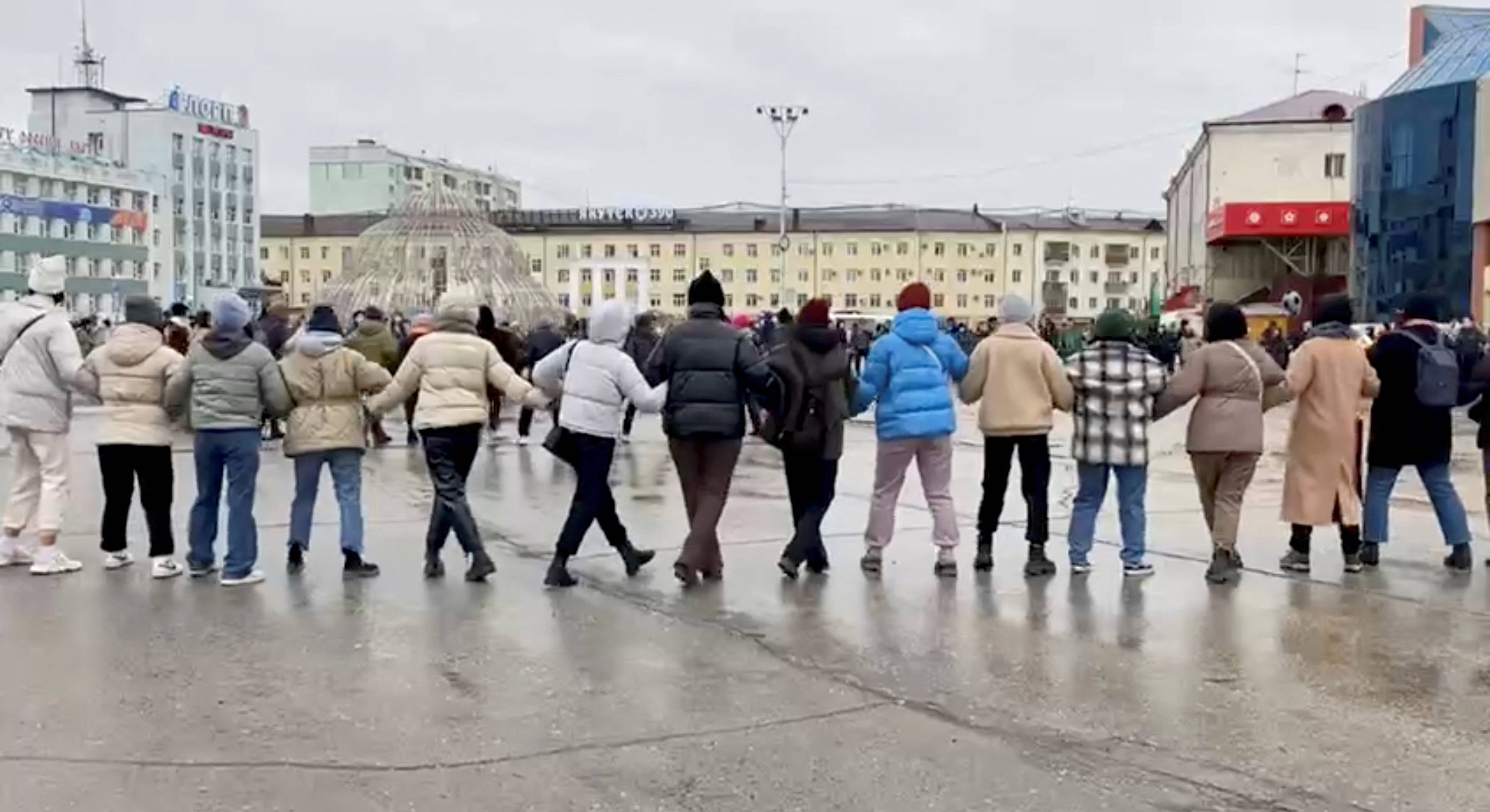 Demonstrators do a traditional dance during a protest against Russia's partial military mobilization in Yakutsk, Russia, on Sunday. | SAKHADAY / via REUTERS