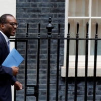 Britain\'s Chancellor of the Exchequer Kwasi Kwarteng walks outside Downing Street in London on Friday. | REUTERS