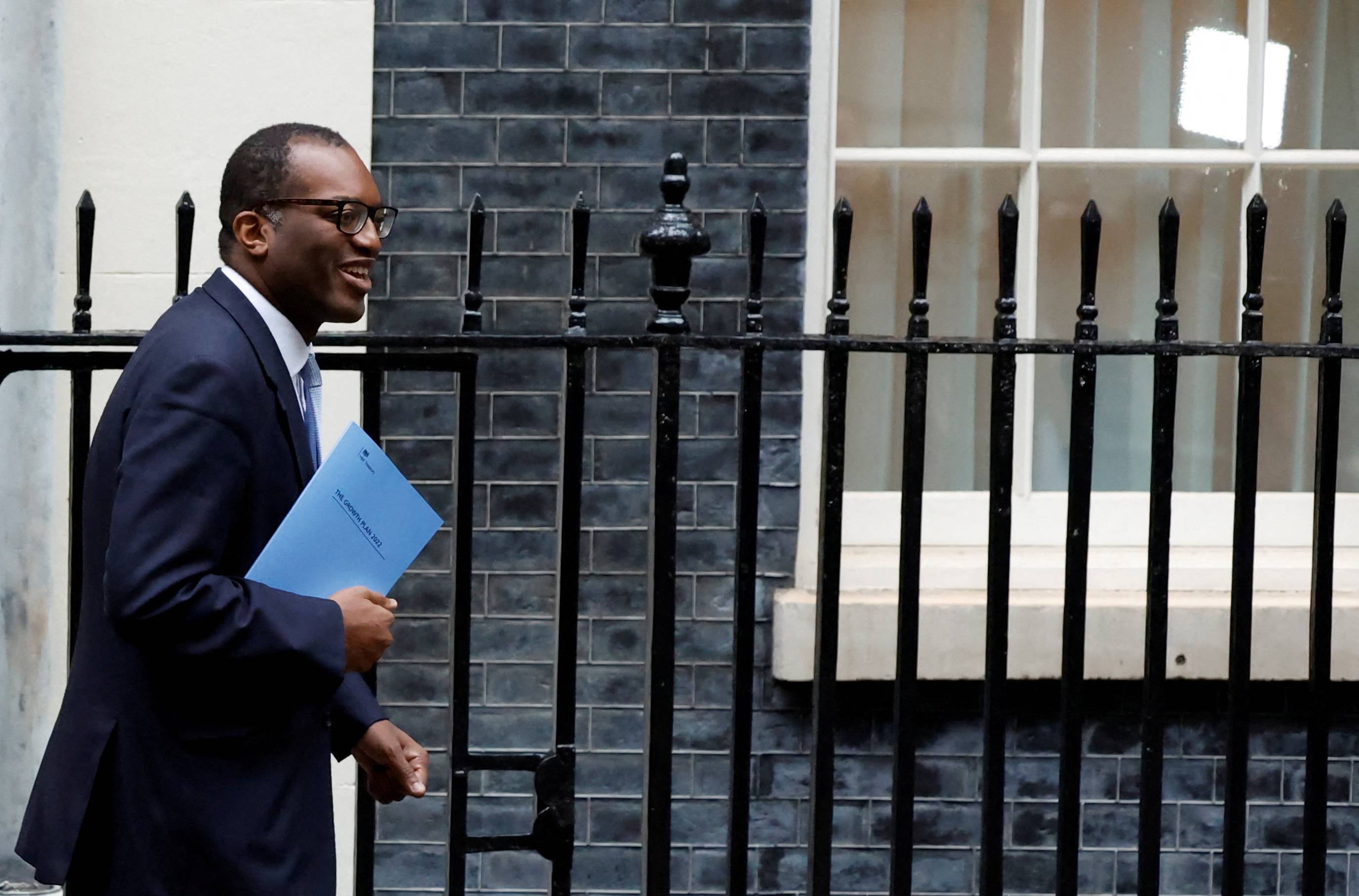 Britain's Chancellor of the Exchequer Kwasi Kwarteng walks outside Downing Street in London on Friday. | REUTERS